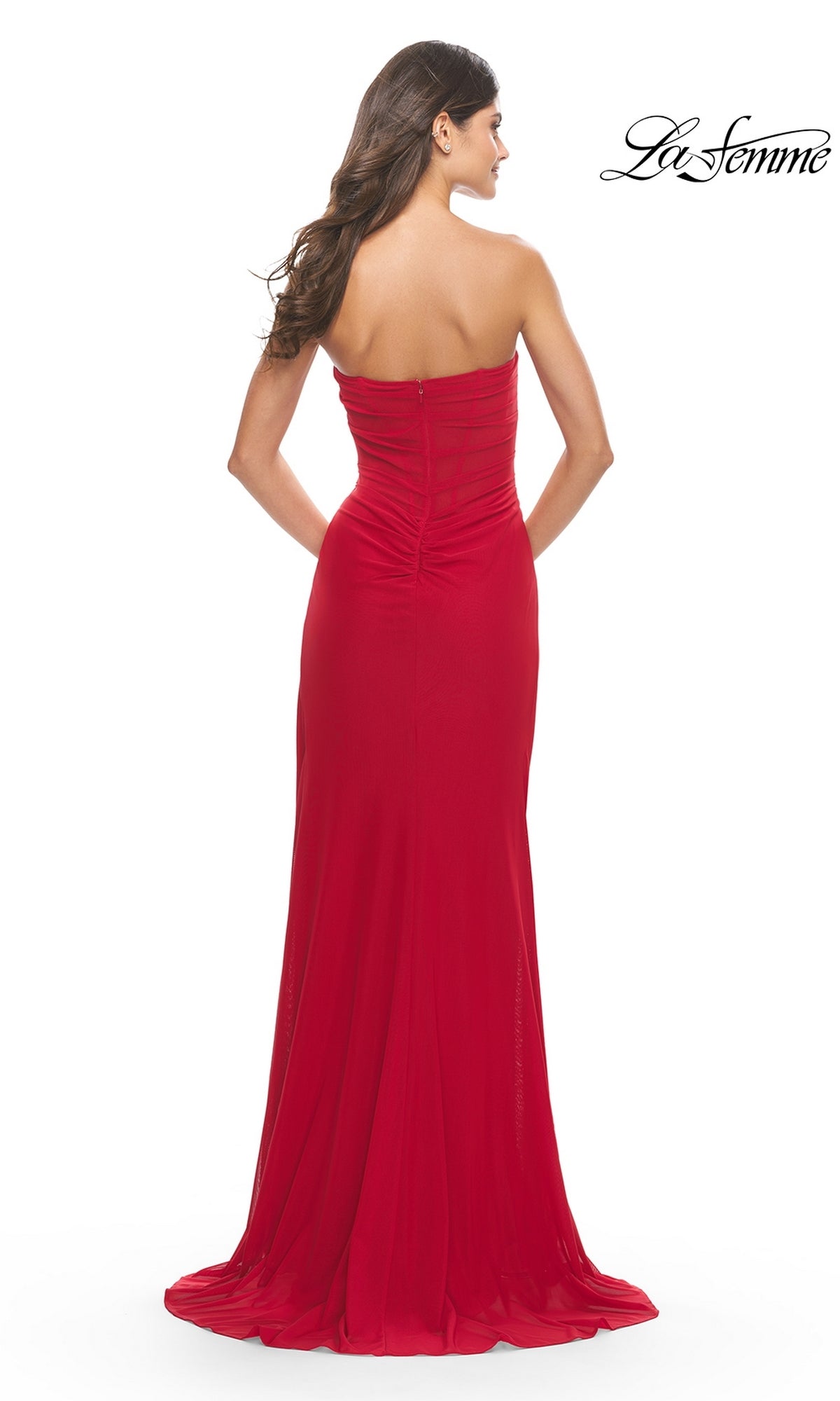 A woman models the Sheer-Bodice Strapless Long La Femme Prom Dress in vibrant red, shown from the back on a plain white background with the